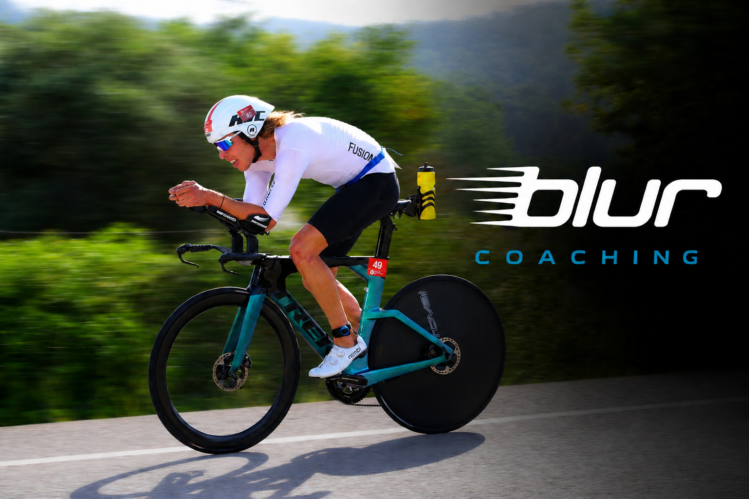 Blair Loggie riding a triathlon bike on a sunlit course